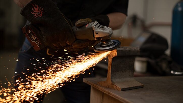 Worker grinding metal parts