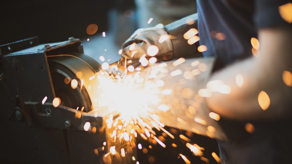 Worker sanding metal material